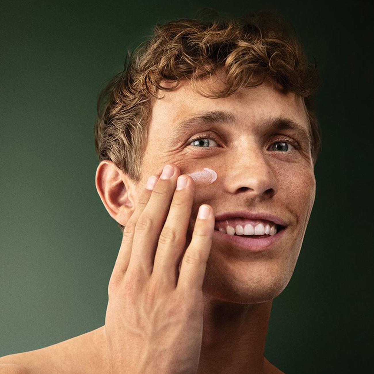 Applying Lavera Men Sensitiv After Shave Balm to face