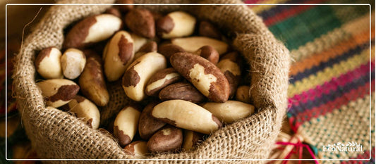 Brazil nuts in a burlap sack on colourful woven fabric