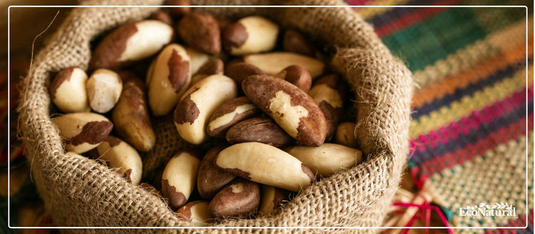 Brazil nuts in a burlap sack on colourful woven fabric