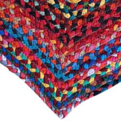 Heart-shaped entry mat made from recycled fabric strips and jute, ethically produced for Shared Earth.