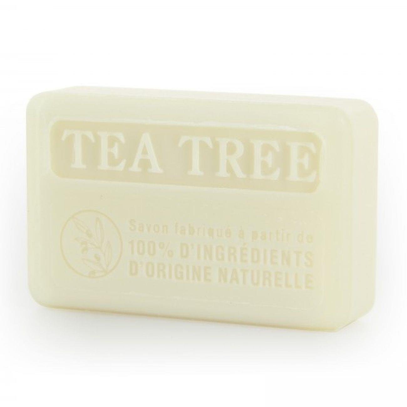 Slightly angled, close-up of 100% natural Savon de Marseille tea tree soap bar, displaying the 'TEA TREE' embossed label and natural ingredients