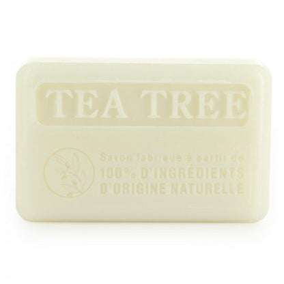 Close-up of 100% natural Savon de Marseille tea tree soap bar, showcasing its embossed 'TEA TREE' label and eco-friendly ingredients.
