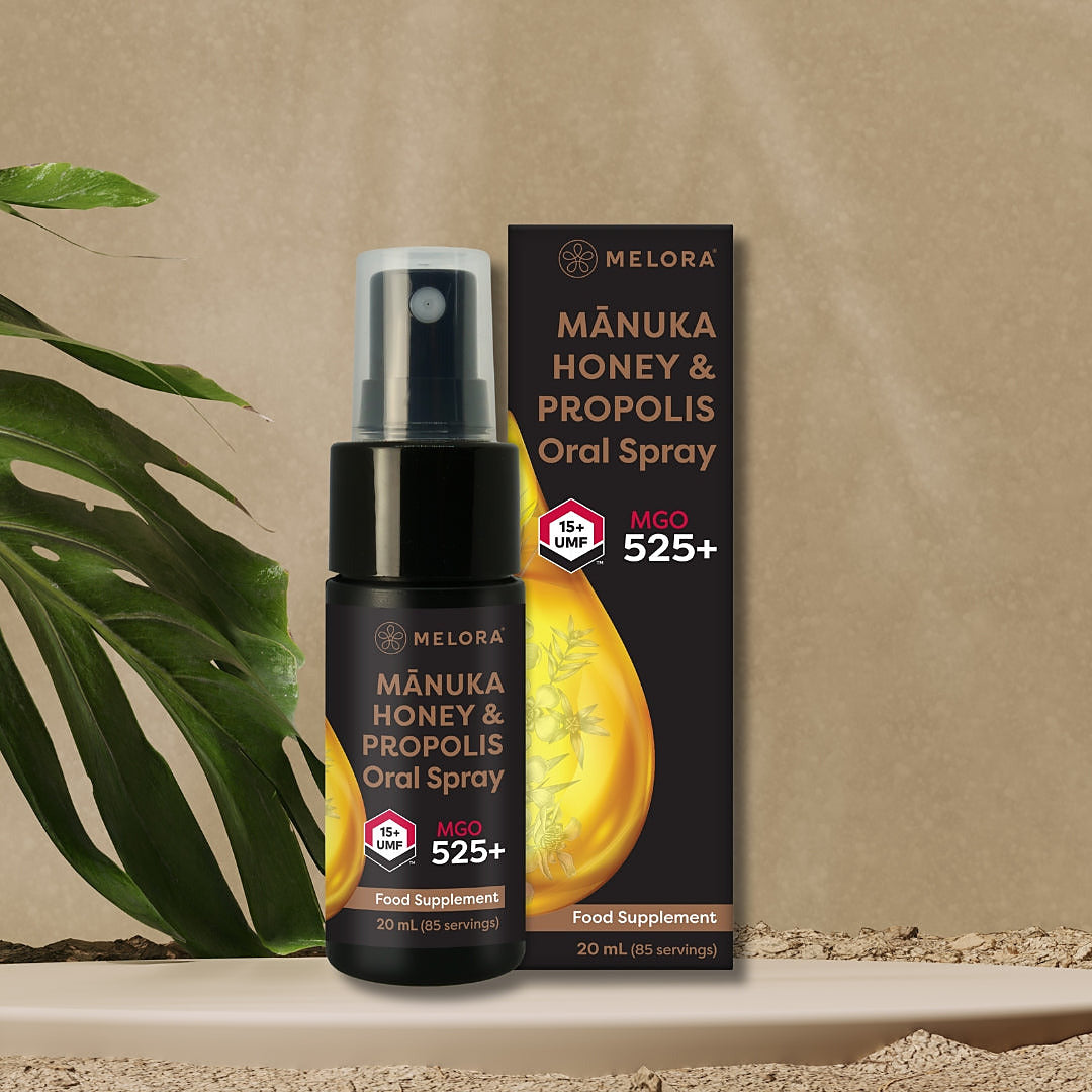 Melora Manuka Honey & Propolis Oral Spray 20ml on a stone plinth with leaves