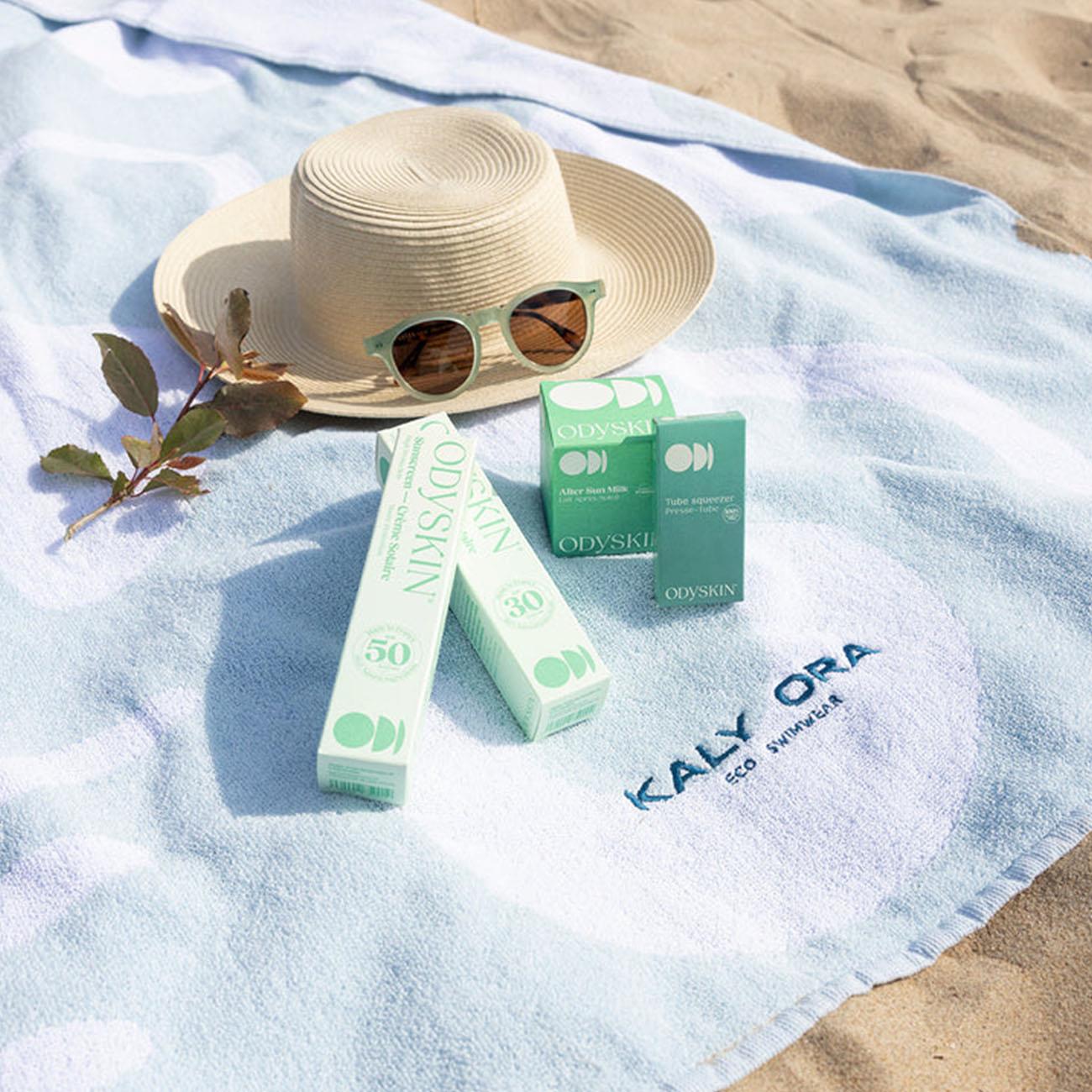 Beach-ready flat lay with Odyskin SPF30 sunscreen